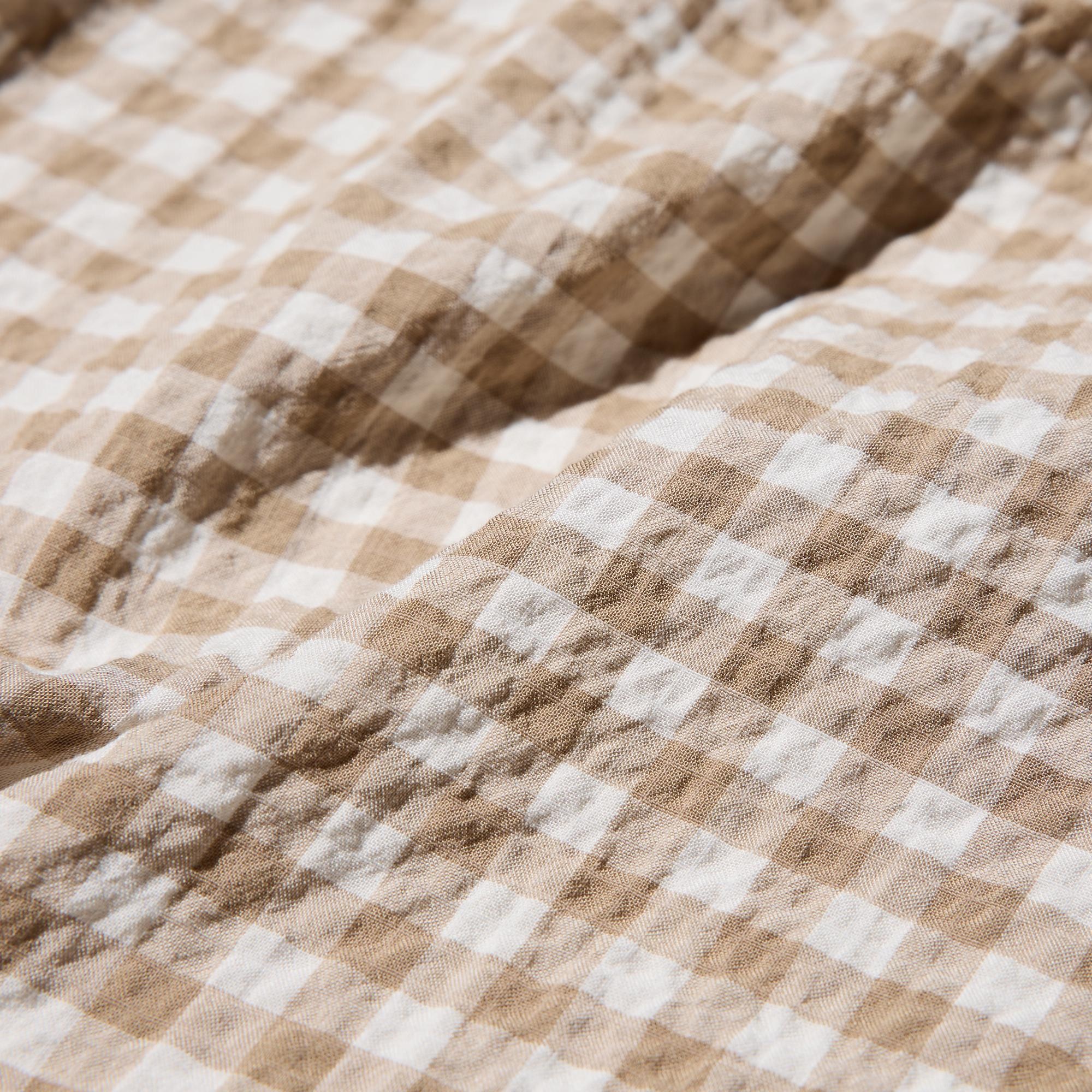 A soft rayon blends with a non-clingy, textured surface. Seersucker fabric for a breezy look. Gingham check.