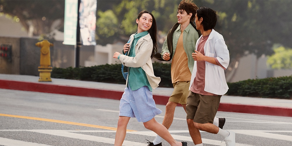 Three models walking across the street wearing Linen products.