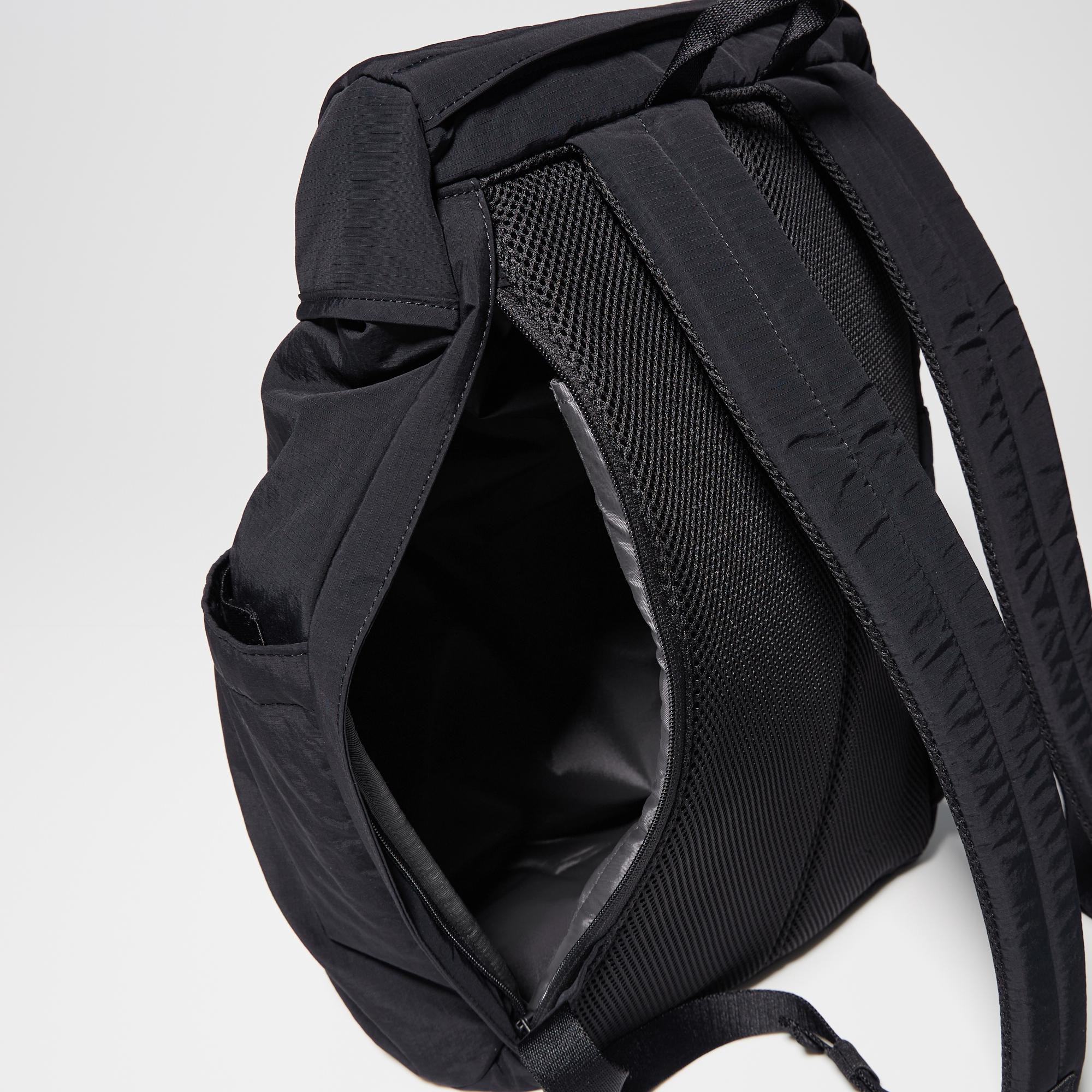 Slide fastener on the back for direct access to the main storage compartment.