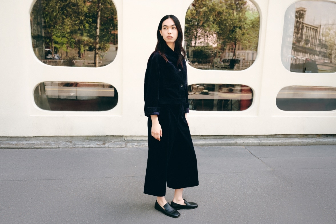 model wearing midnight jacket and black wide leg cropped trousers with black loafers