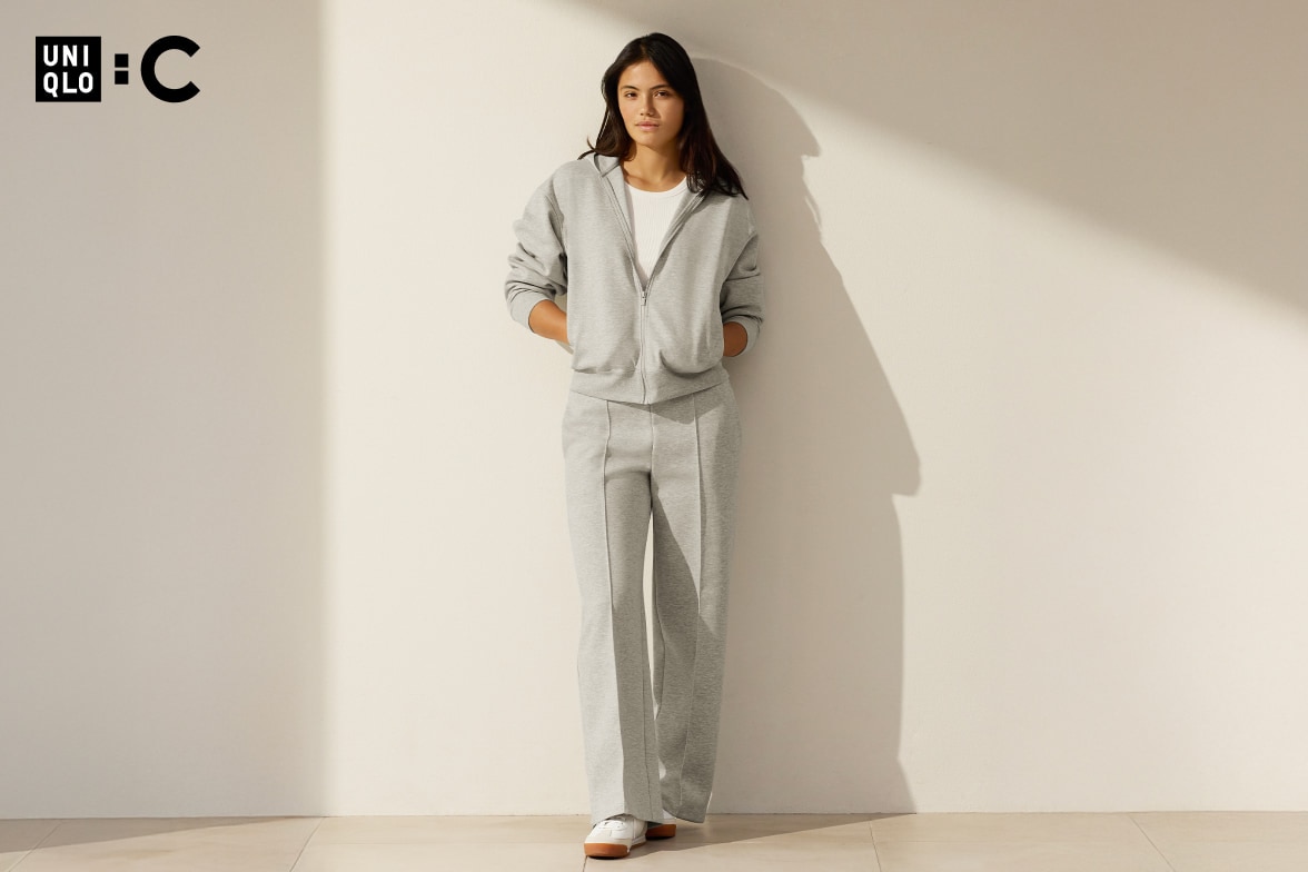 Emma Raducanu wearing gray zip-up hoodie and pleated sweatpants
