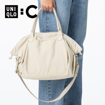 model wearing blue jeans carrying a Drawstring Bag in cream