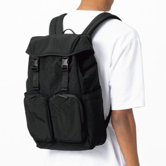 model wearing a white T-shirt and a Multi Pocket Backpack in black