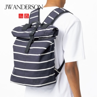 model wearing a white T-shirt with a Roll Top Backpack in a navy and white striped design