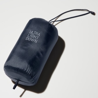 ultra light down jacket folded away into its navy storage pouch