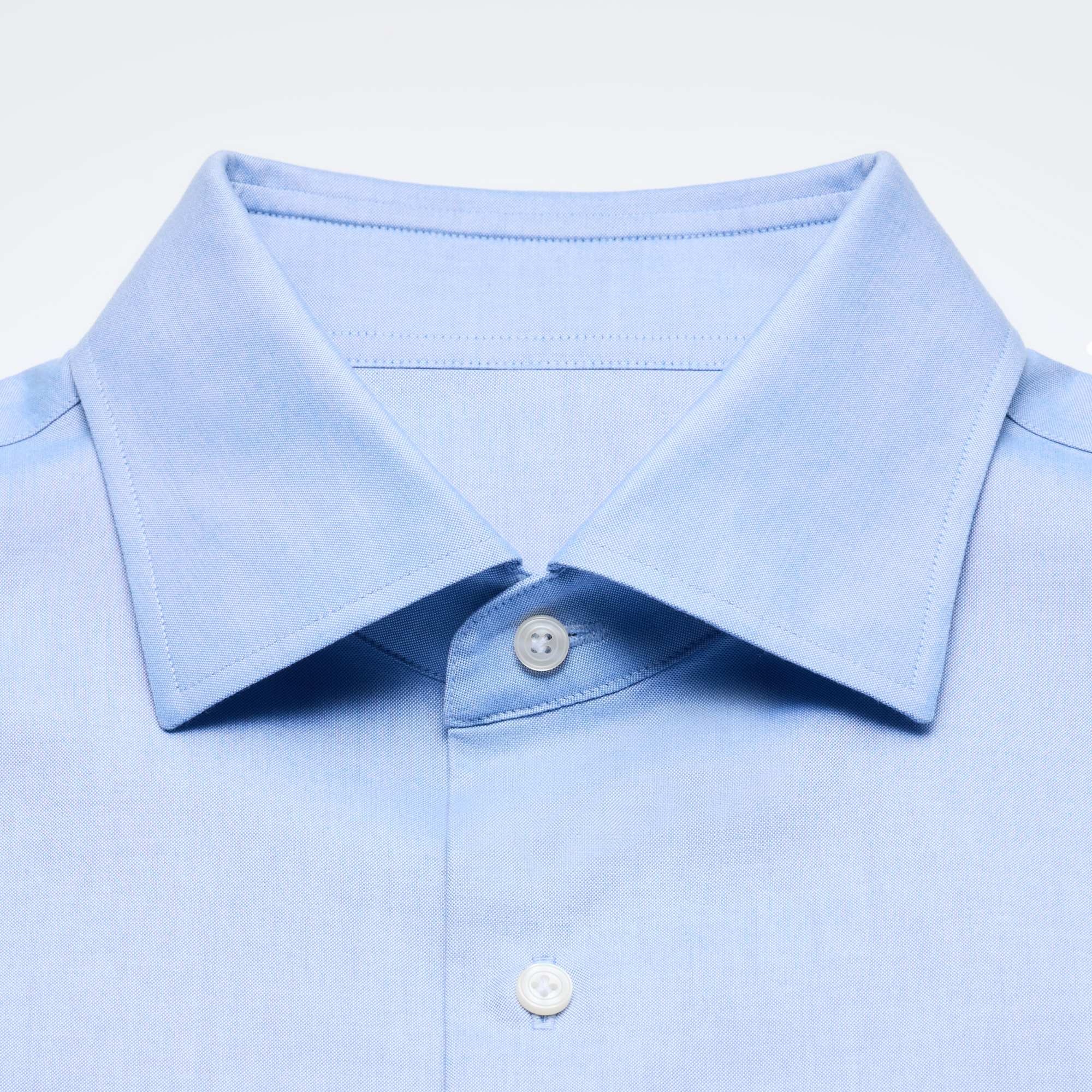 close-up of a spread collar on a light blue shirt