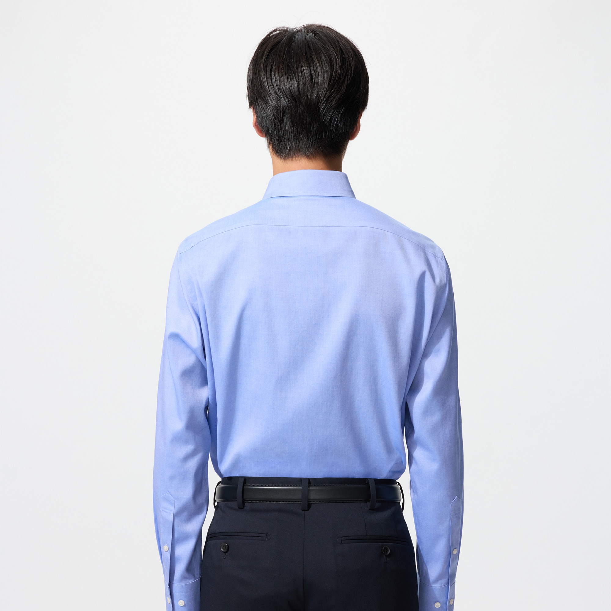 model wearing a Slim Fit shirt in light blue, shown from the back