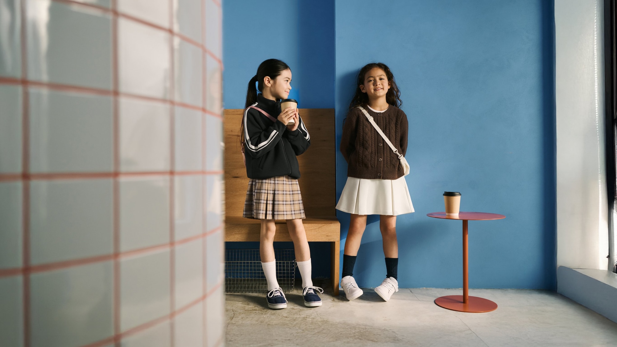 two models wearing UNIQLO skorts, one white, one light brown check