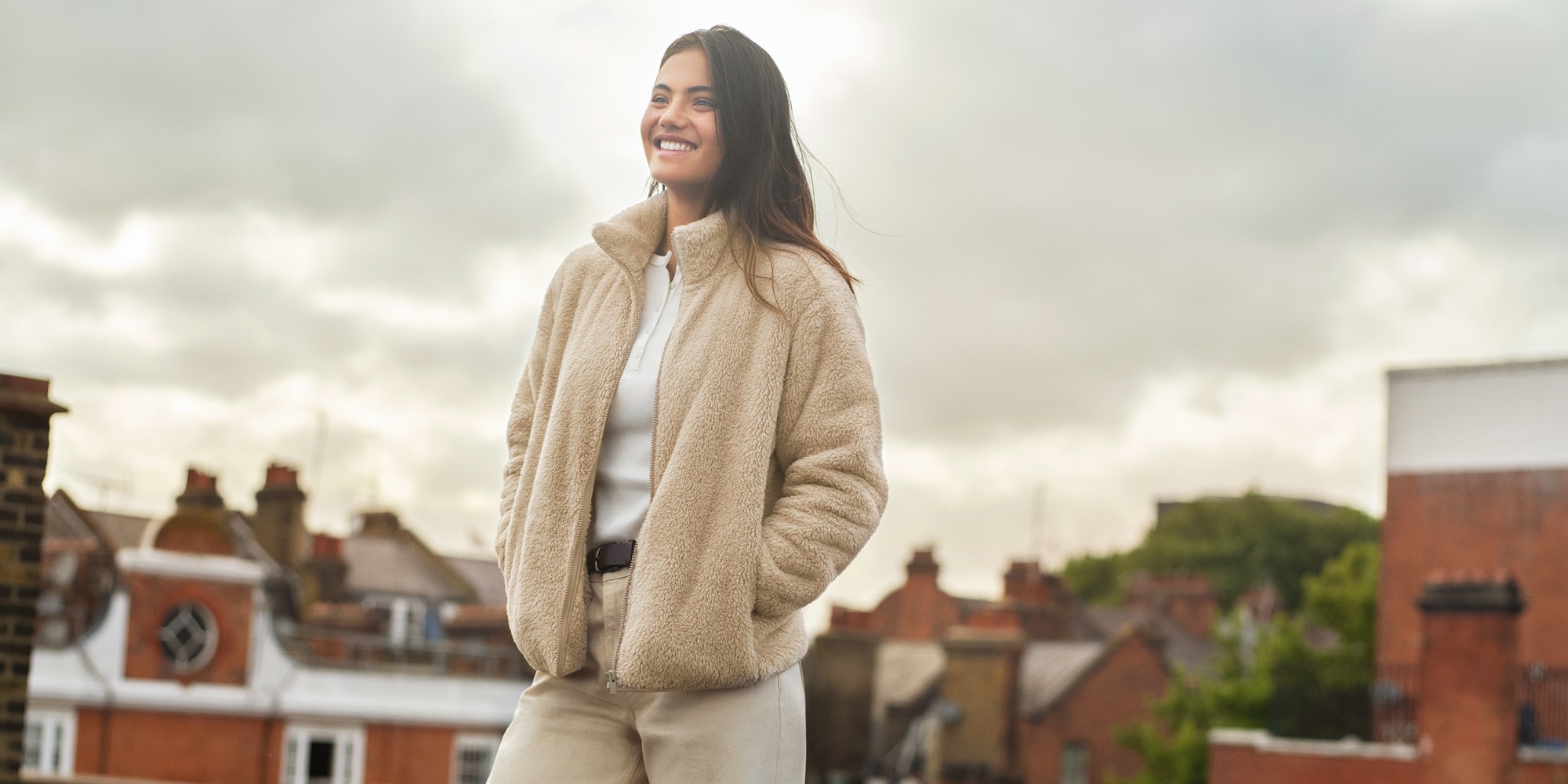 Professional Tennis Player Emma Raducanu wearing a beige Fleece jacket with beige jeans