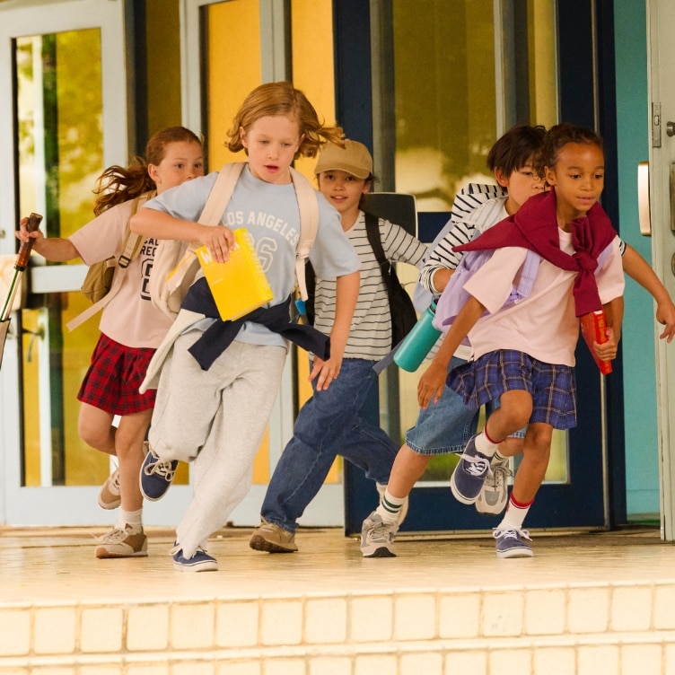 five models running out of school wearing joggers and jeans