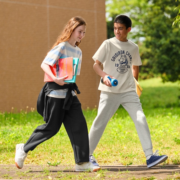 two models wearing DRY Sweat Joggers in black and light grey while walking outside