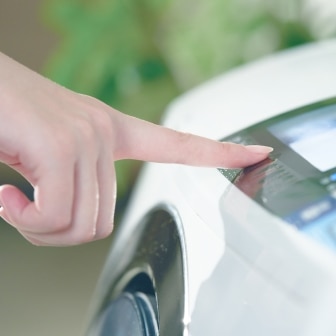 finger shown selecting the cycle on a washing machine