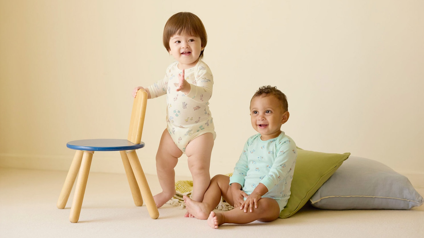 two models wearing UNIQLO printed bodysuits