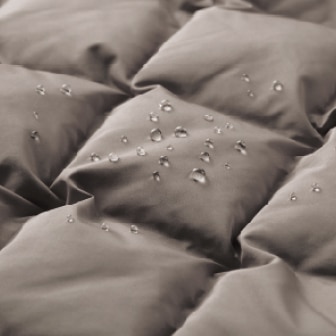 close-up of water droplets forming on the surface of a puffertech jacket