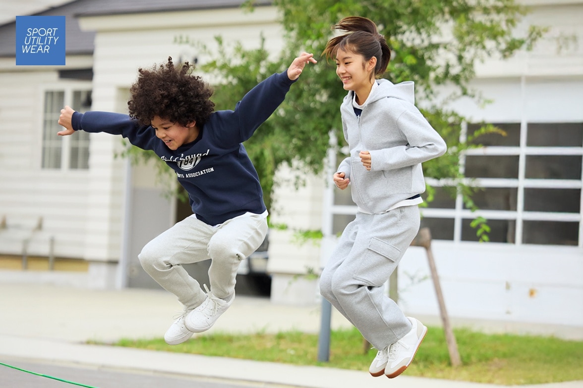 two models wearing UNIQLO sweats while jumping