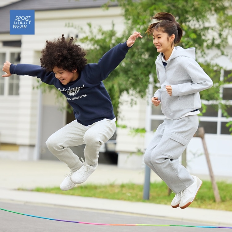 two models wearing UNIQLO sweats while jumping