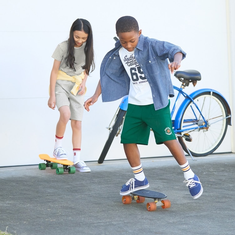 two models wearing UNIQLO shorts while skateboarding