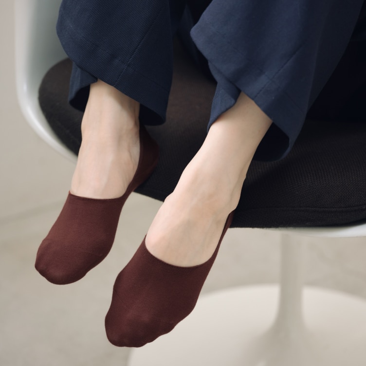 a pair of feet wearing No-Show Socks in dark brown
