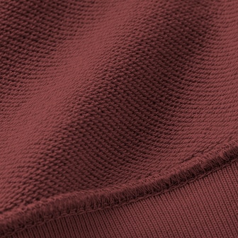 The inner layer has a lining with a series of fine loops. It has a gentle texture with moderate volume, like a towel.
