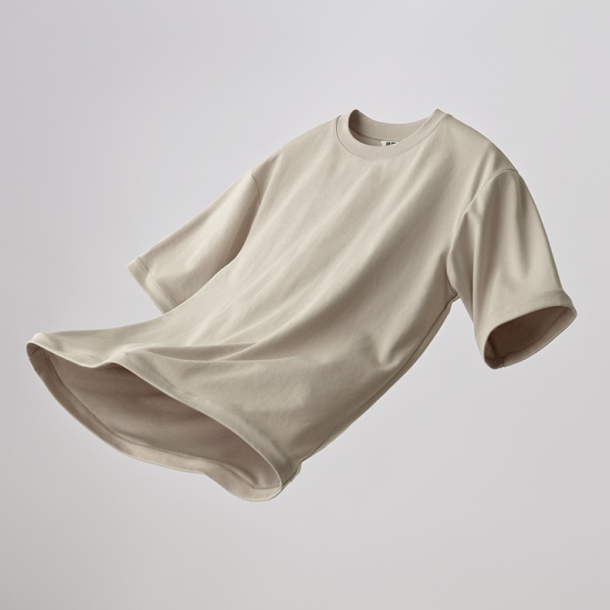 AIRism Cotton Oversized Crew Neck T-Shirt in beige suspended against a light grey background