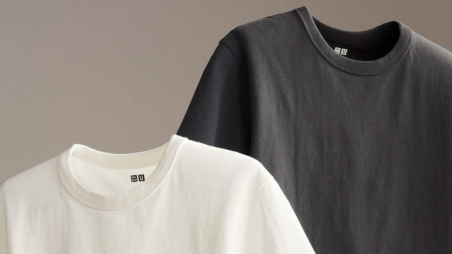 Crew Neck T-Shirt in white and dark grey, suspended against a grey background