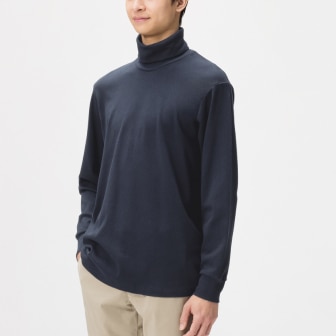 model wearing Soft Brushed Turtleneck T-Shirt in dark grey with beige trousers