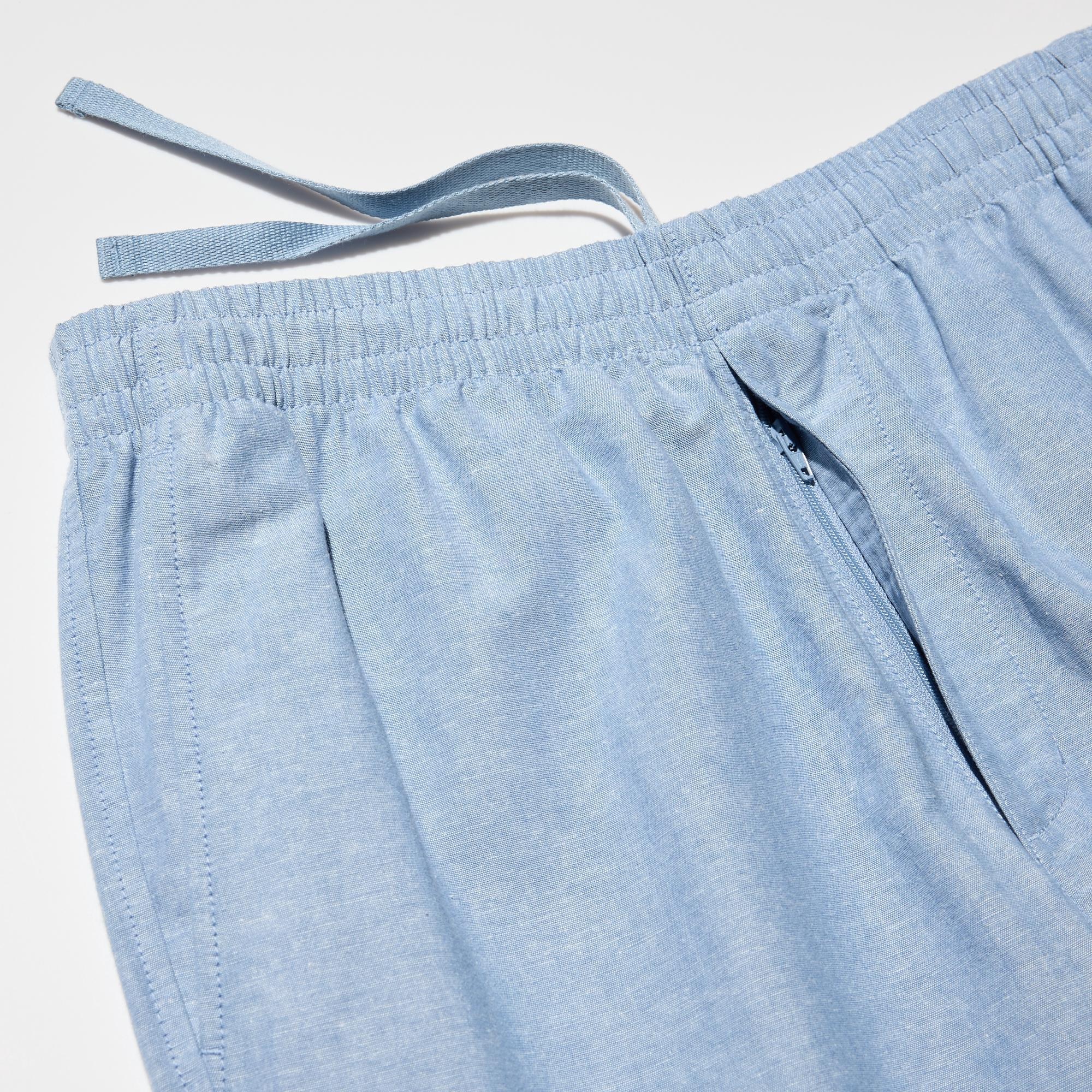 Front opening, slide fastener closure and an elastic waistband with a drawstring for size adjustment.