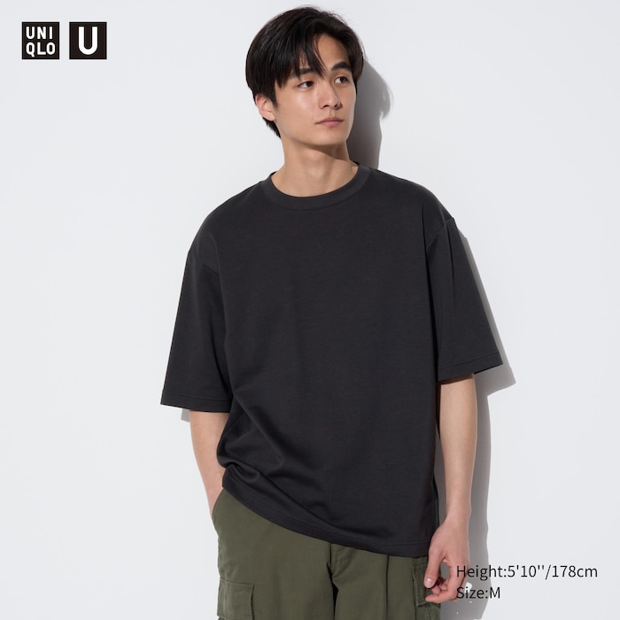 Asian male wearing Uniqlo U Crew Neck T Shirt in black with blue pants