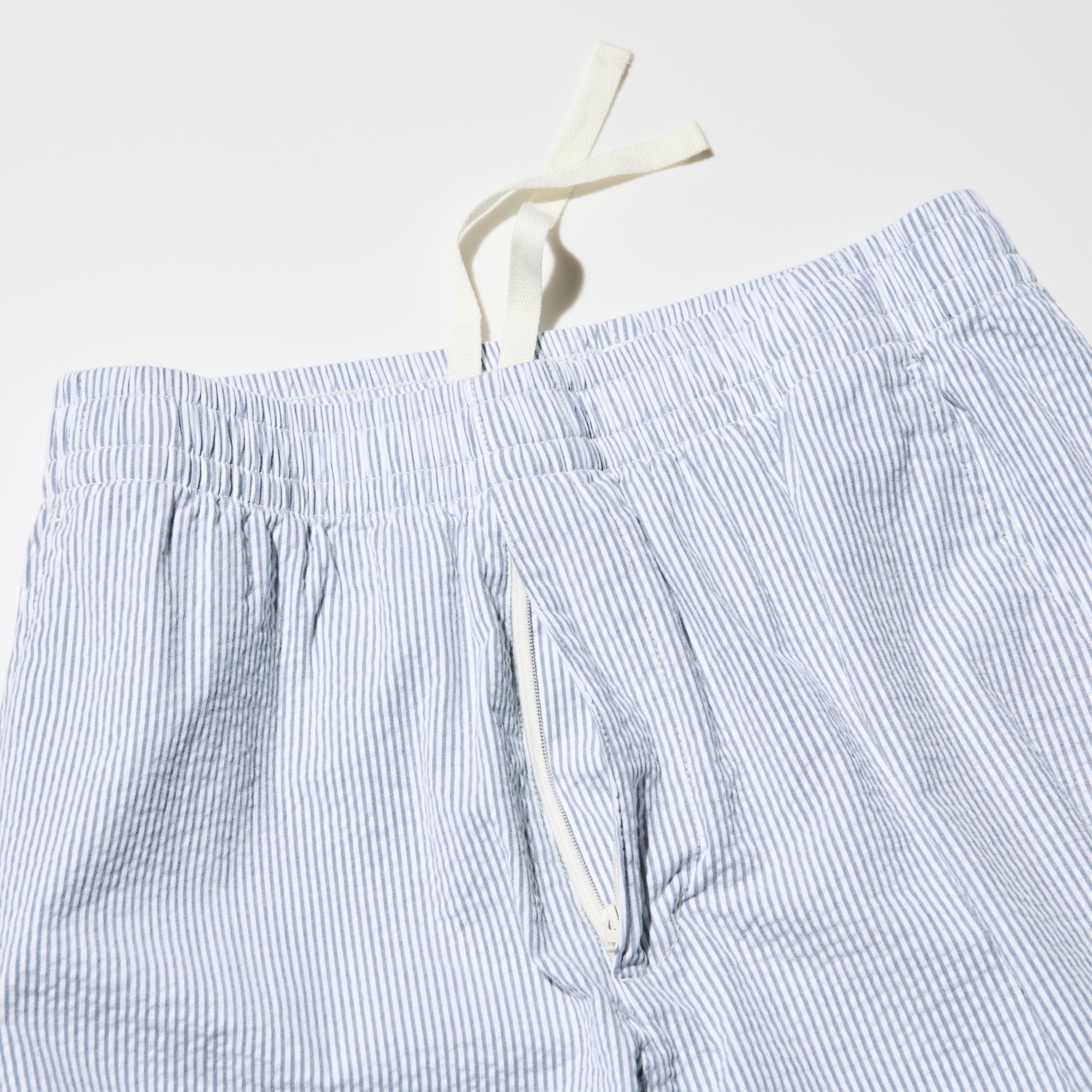 Front opening with slide fastener. Elastic waistband with a drawstring for size adjustment.