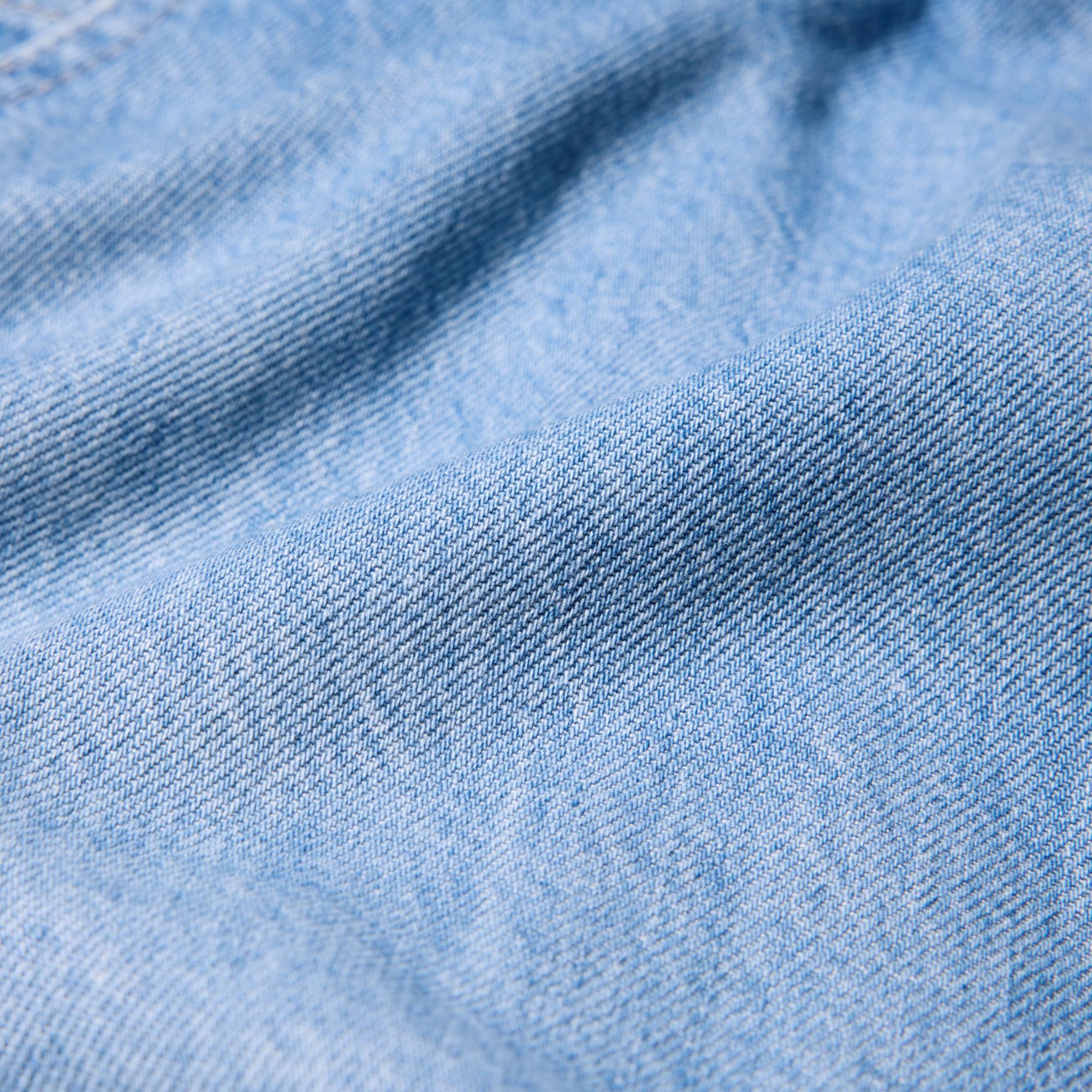 Soft, lightweight, and breathable drape denim fabric made from a blend of cotton and lyocell.