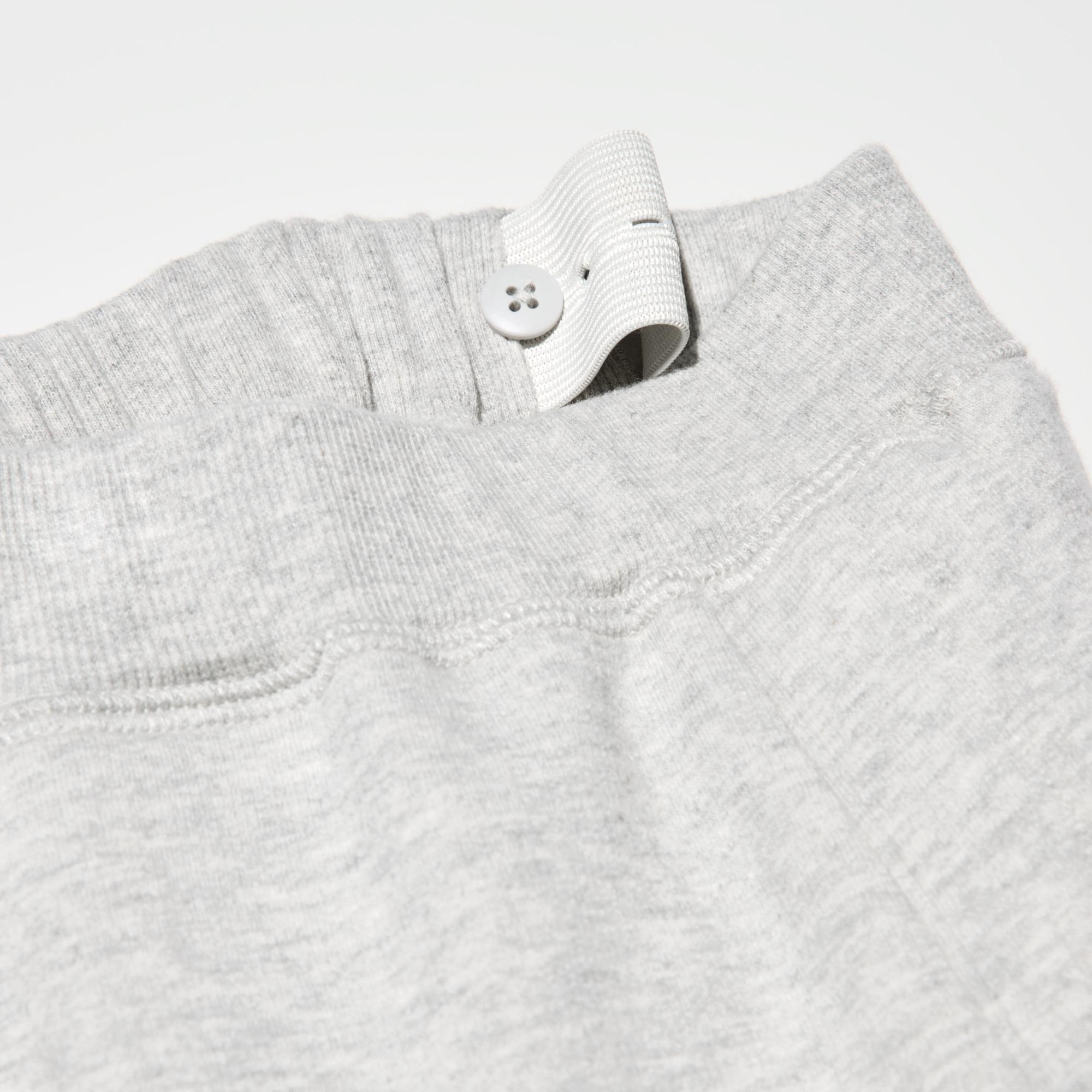 To adjust the fit, pull the elastic waistband through the opening and button at the desired location.