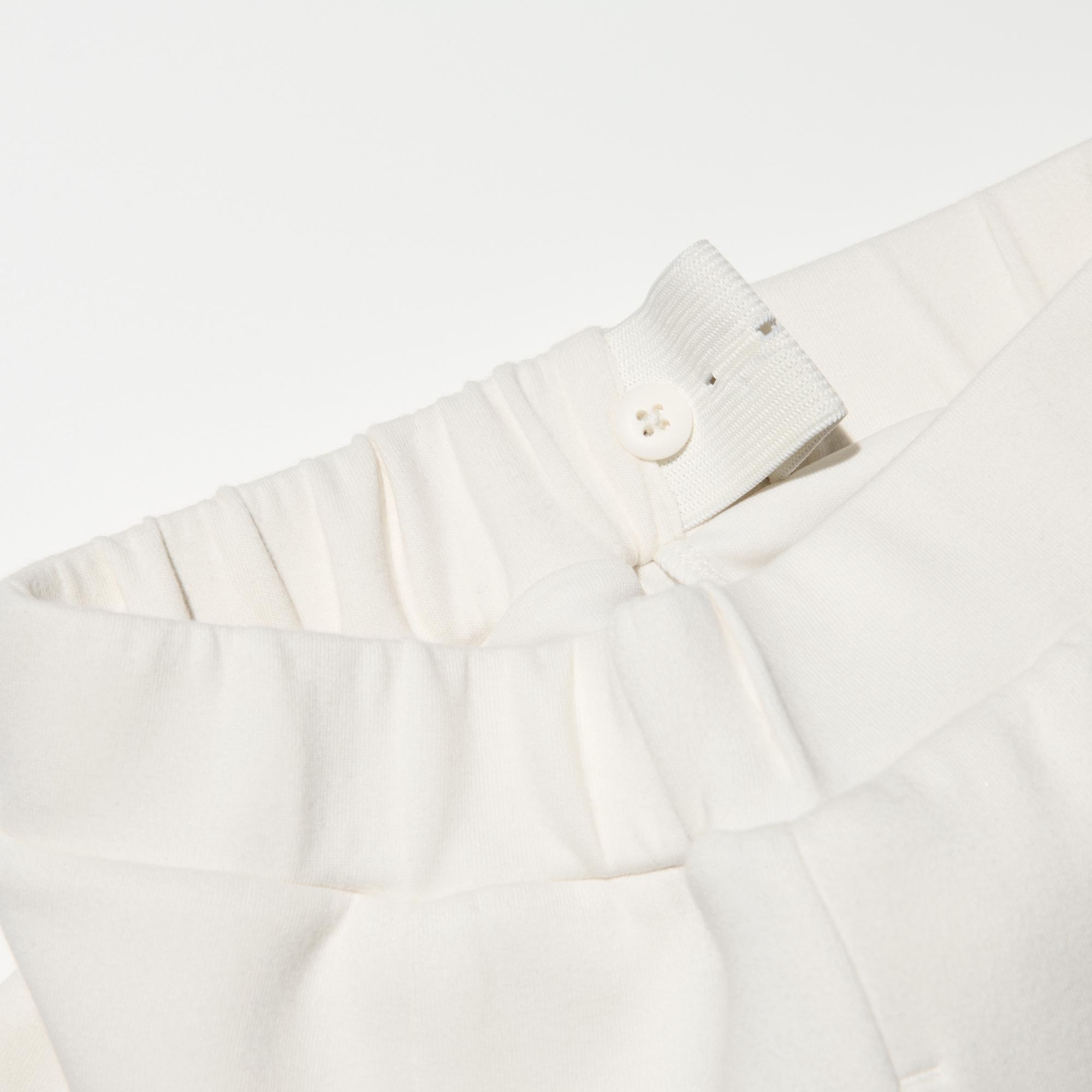 To adjust the fit, pull the elastic waistband through the opening and button at the desired location.