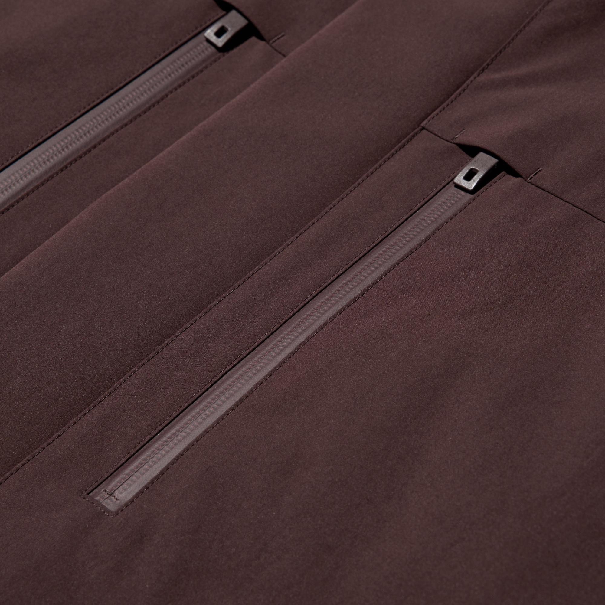 Features a water resistant fastener at the chest pocket and a front placket designed to keep out the rain and wind.