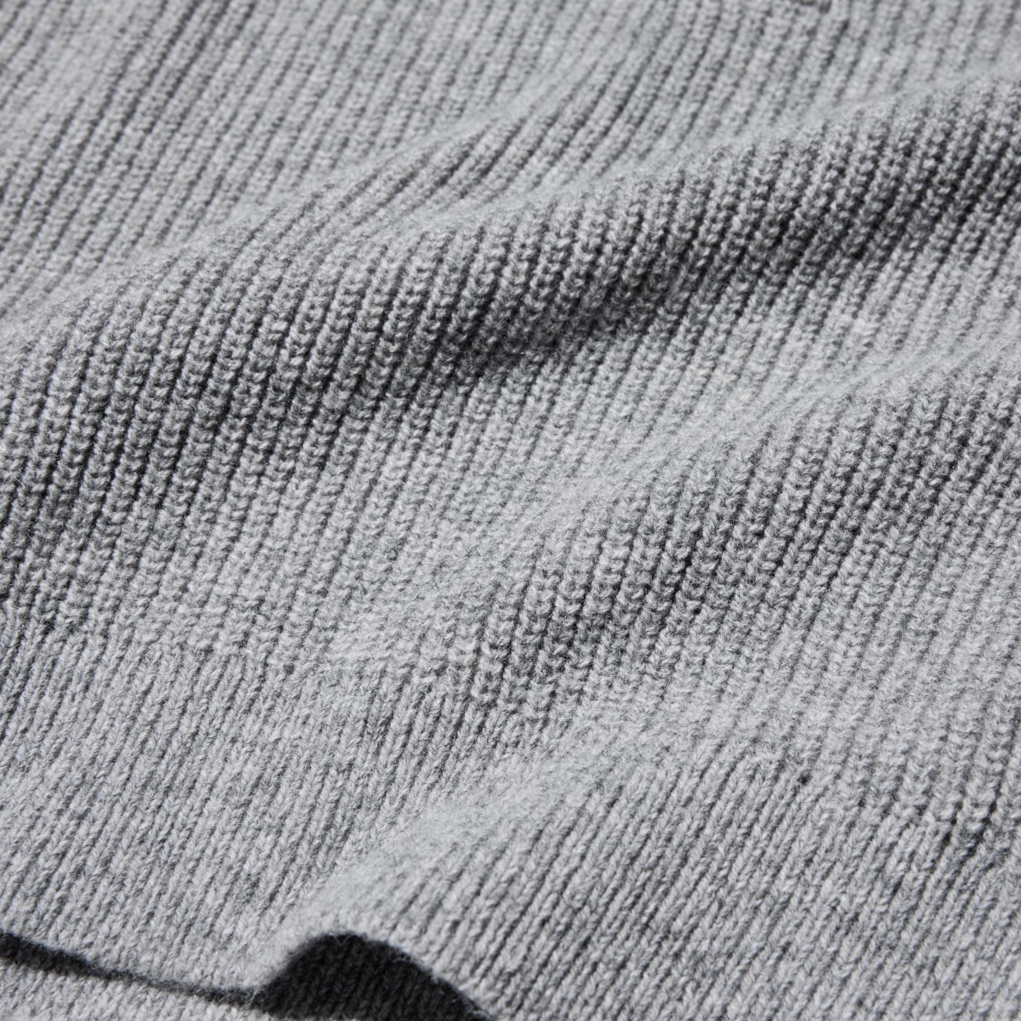 Wool blend in a ribbed knit. The vertical lines of the knit fabric lend a sleek look.