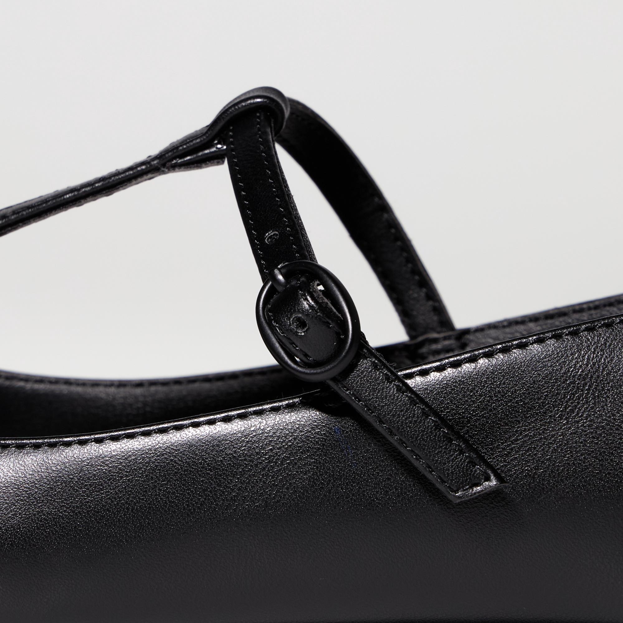 Т-бау дизайнымен ерекшеленген жалпақ аяқ киім. Тоғалы баумен реттелетін бекіту. Оңай қосу/өшіру үшін табандағы серпімді белдік.