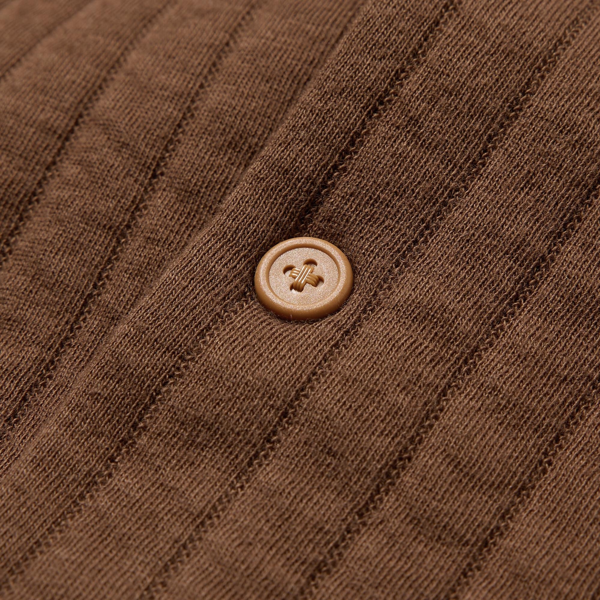 Large button-style snap-fasteners for easy fastening.