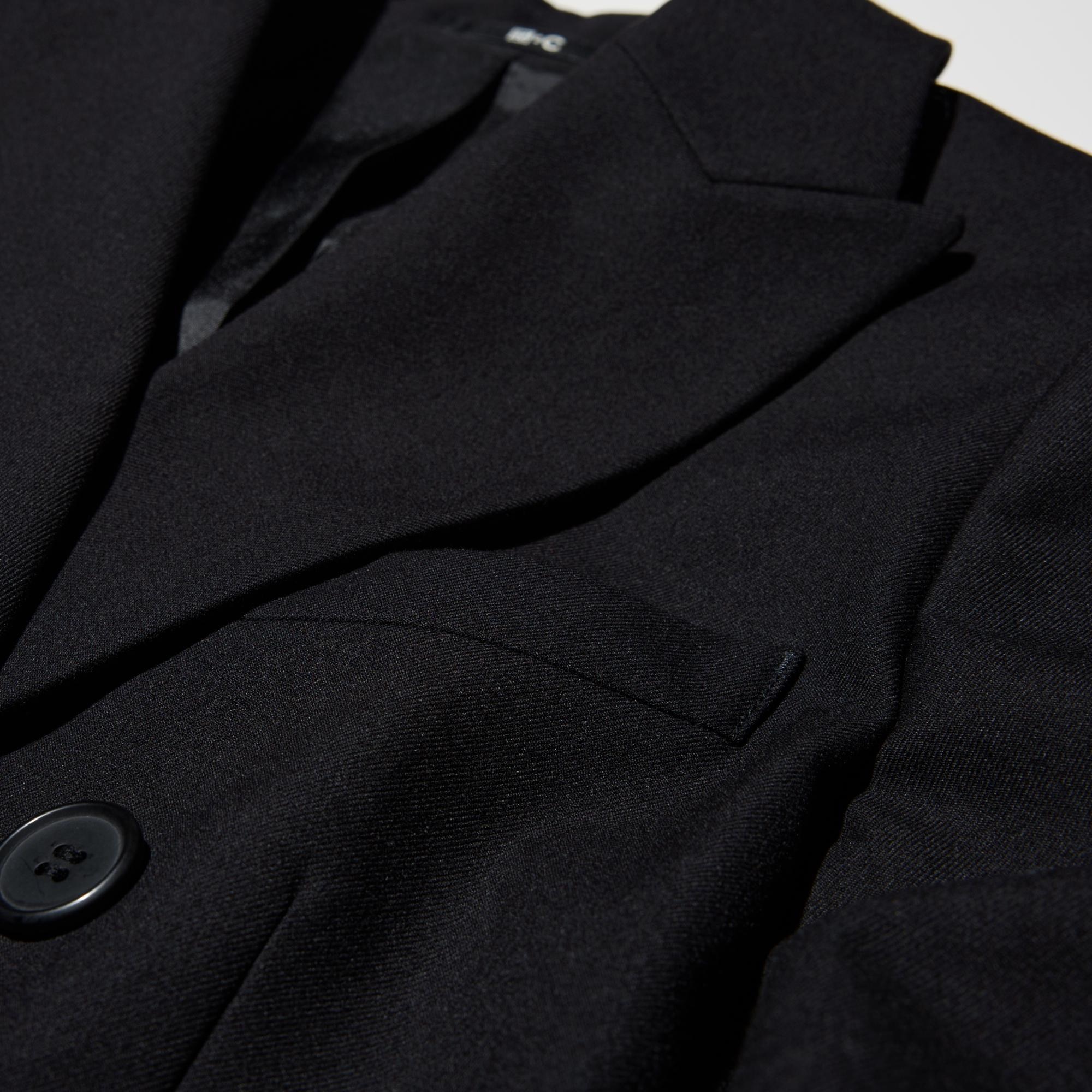 Double breasted design and fabric with a tailored look.