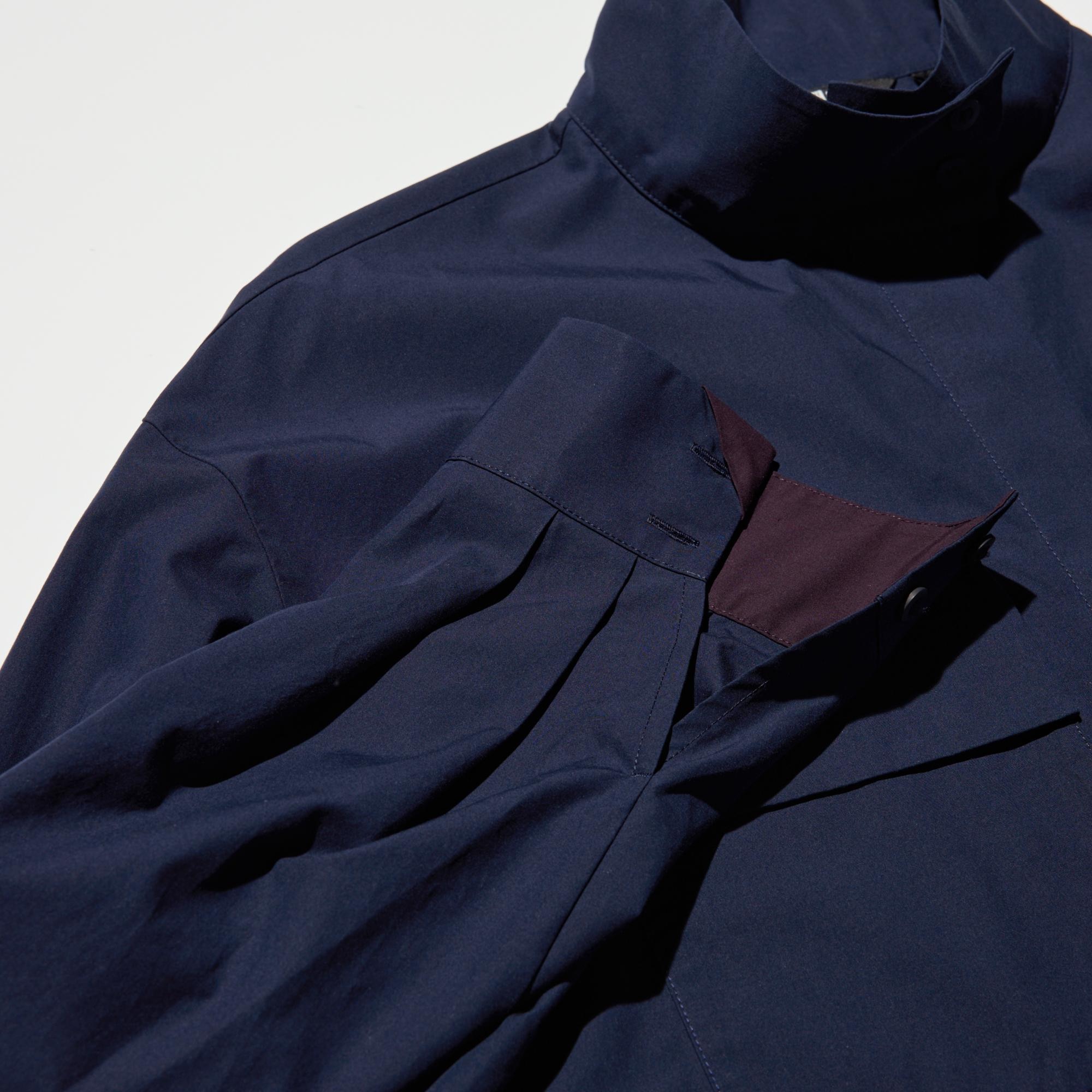Stand collar. Accent color at the sleeves and placket.