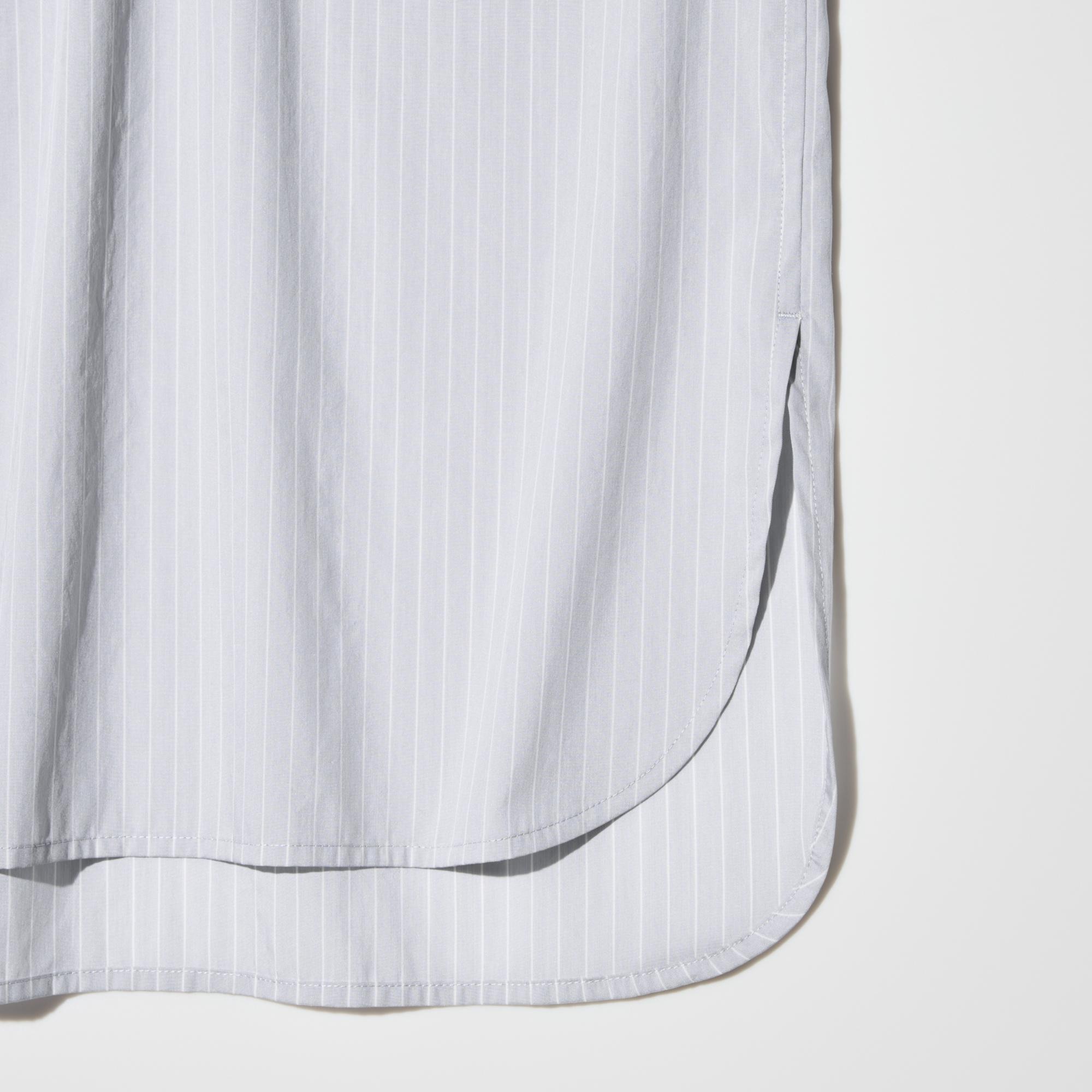 Loose cut with a rounded hem and side slits.