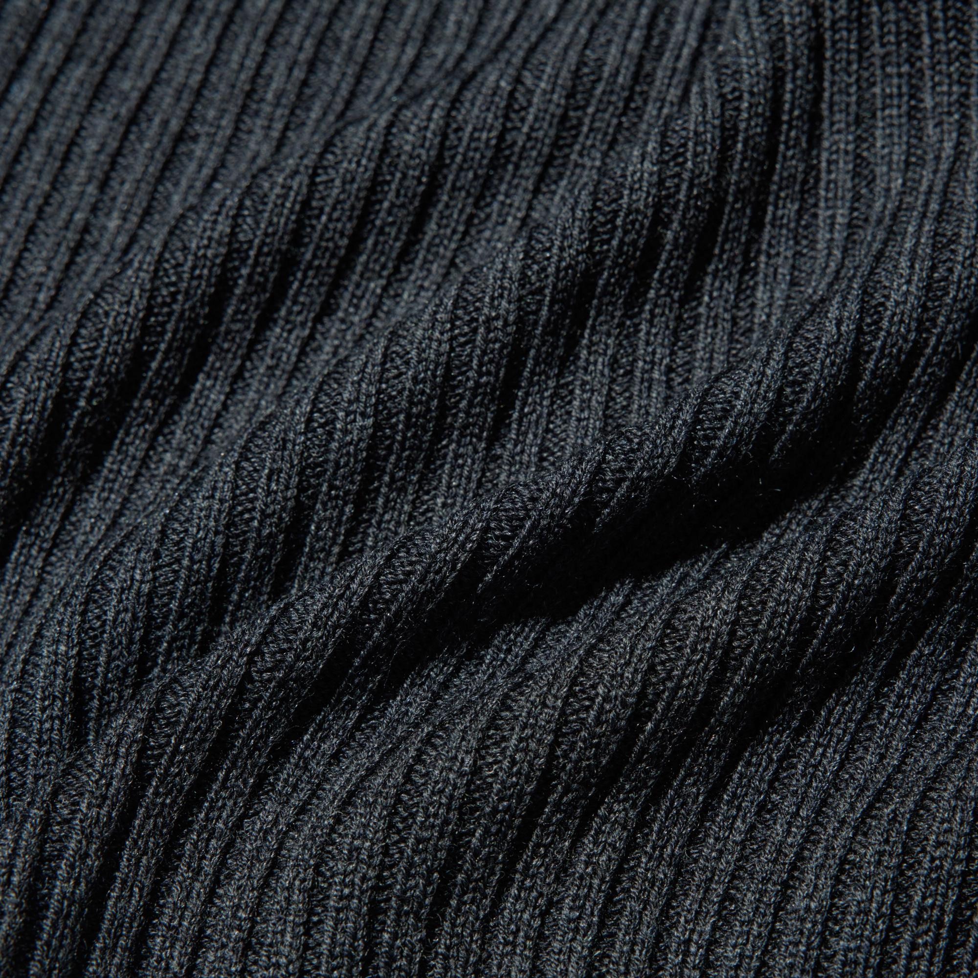 Mid-gauge ribbed merino blend fabric with distinctive stitch variations.