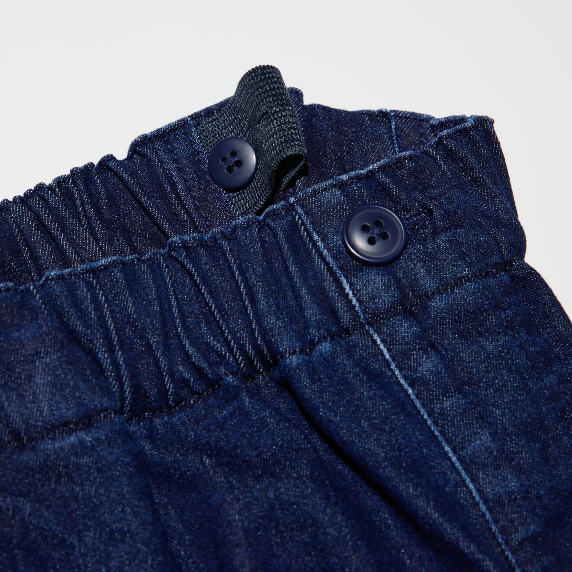 To adjust the fit, pull the elastic waistband through the opening and button at the desired location.