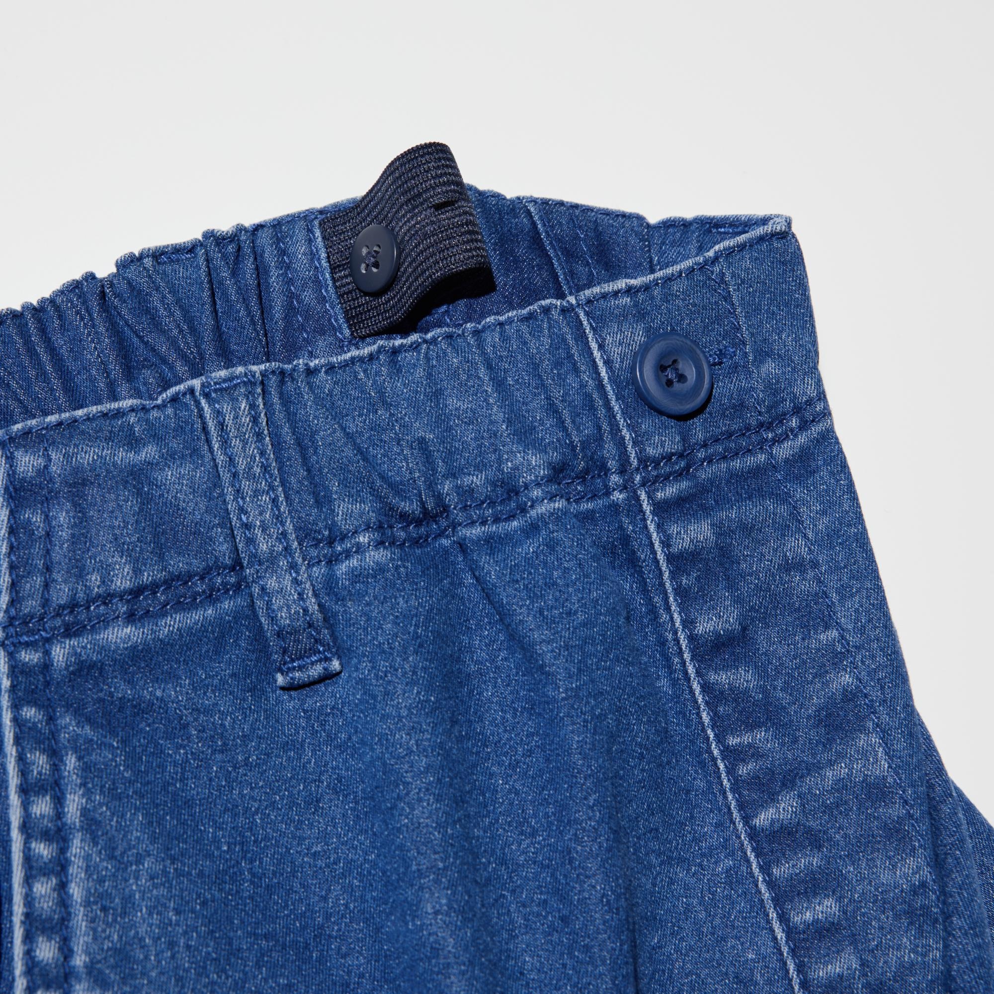To adjust the fit, pull the elastic waistband through the opening and button at the desired location.