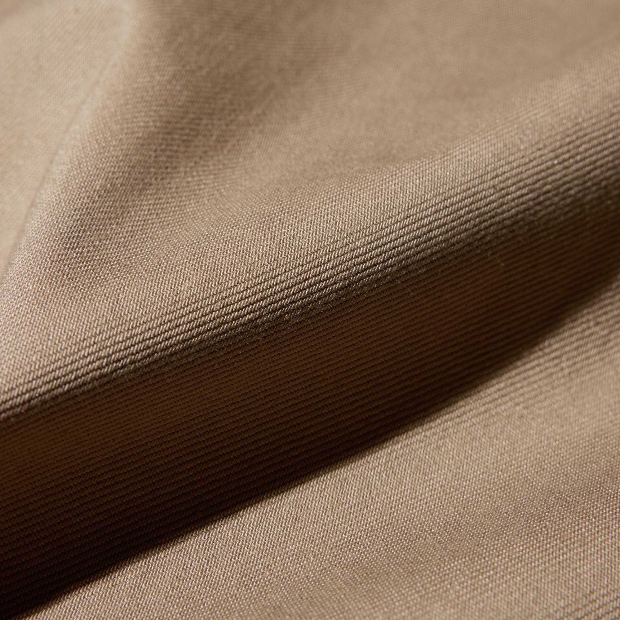 Moderately crisp twill fabric creates an elegant silhouette.