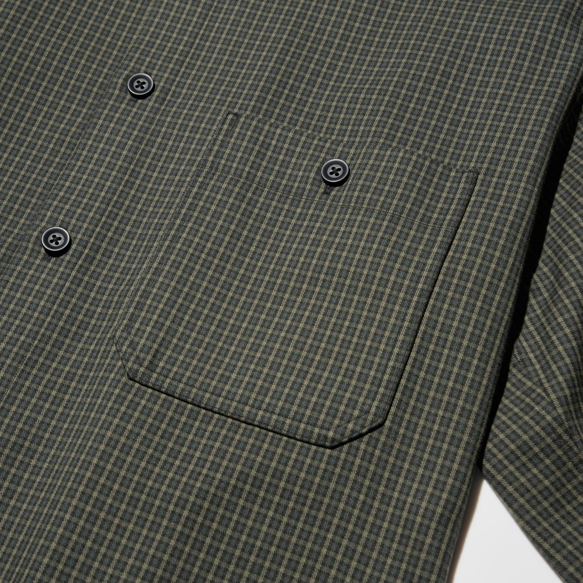 Workwear-style details, including large buttons and double stitching at the collar and pockets.