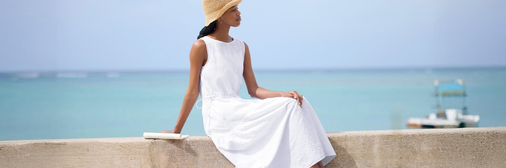 Model near the coast, wearing a white sleeveless Linen Blend Tiered Dress