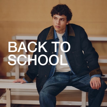 Text overlay of "Back to school" over a man wearing a black jacket with brown collar, white shirt, and denim jeans.
